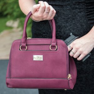 This concealed carry purse features ambidextrous access with a zippered three-sided pocket located on the front of the bag.